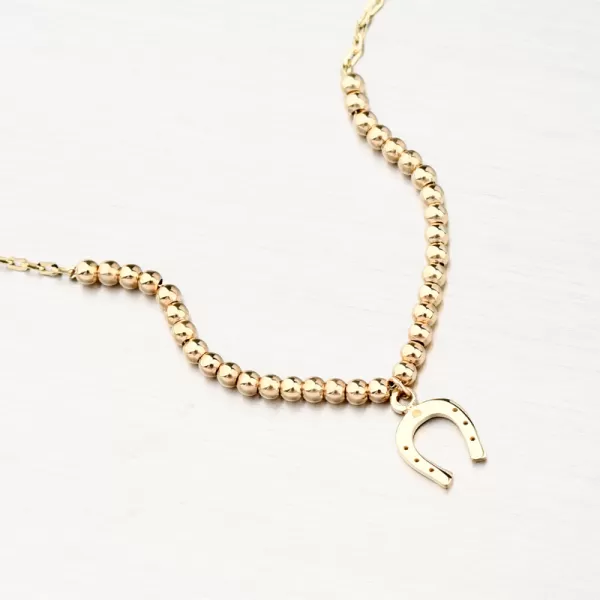 Zlatý náramek s kuličkami a podkovou 144P-141240